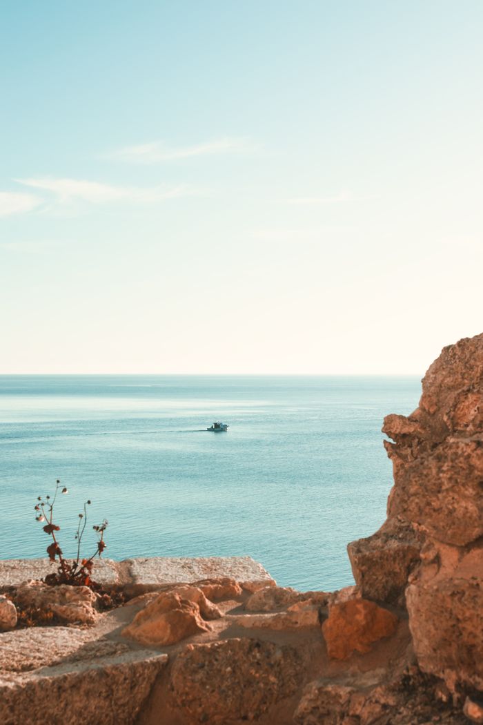 A tranquil view of the sea from Gelibolu, Turkey with a boat on the horizon.